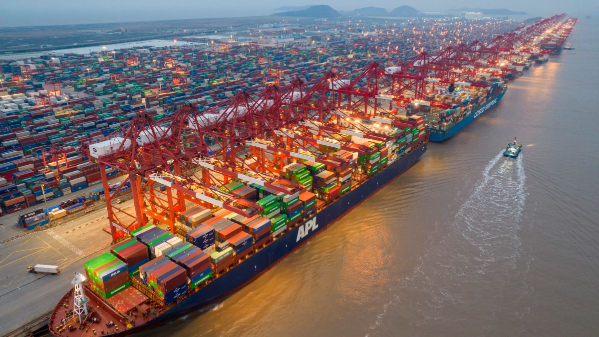 Container ships, cranes and stacked containers at a port.