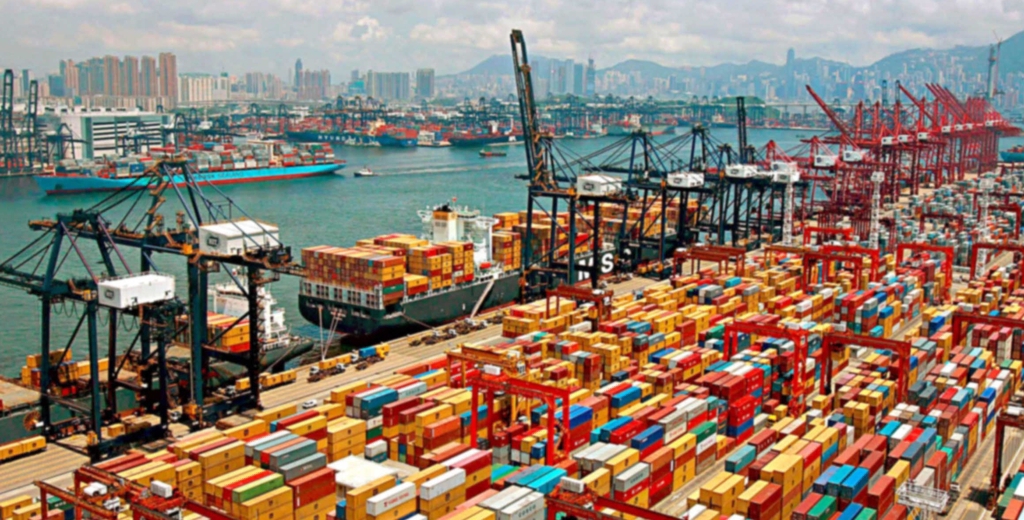 Shipping containers and cranes at a busy container port.