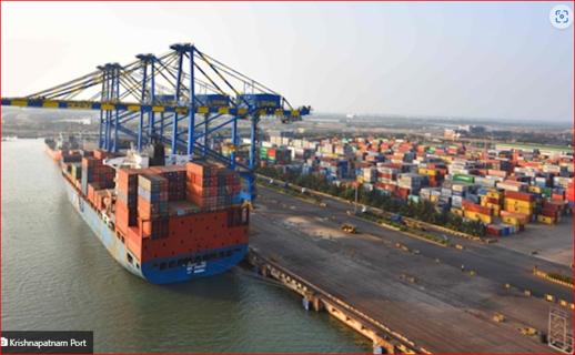 Container ship alongside a terminal with cranes and stacked containers.